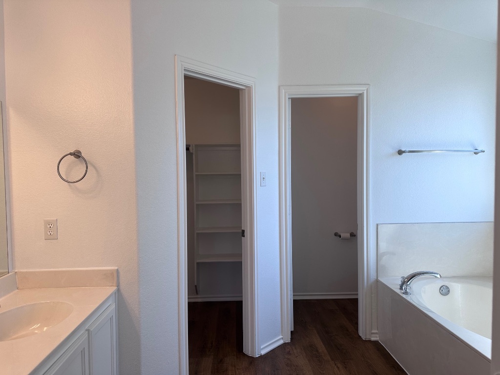 12720 Waynespur Lane Elgin, TX 78621 - Photo 25 of 31 a bathroom with a tub a sink and a shower