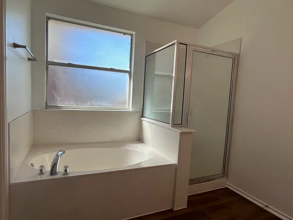 a bathroom with a bathtub and a shower