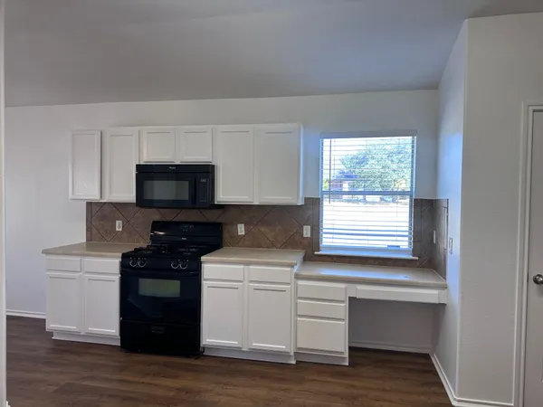 a kitchen with a stove and a microwave