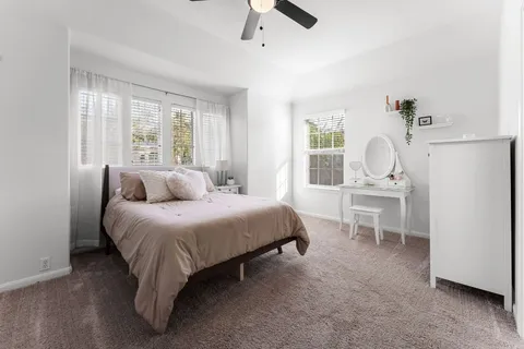 a living room with furniture a window and a flat screen tv