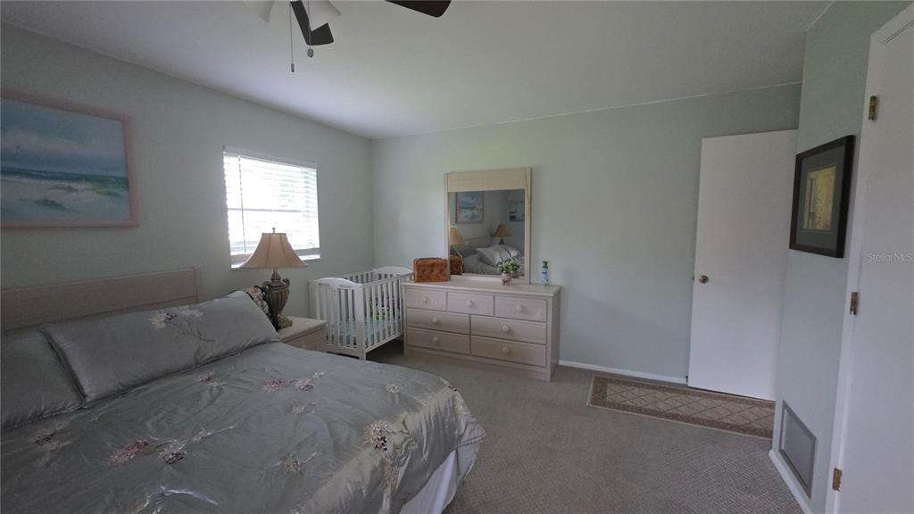 199 Caddy Road Rotonda West, FL 33947 - Photo 7 of 20 a bedroom with bed and window