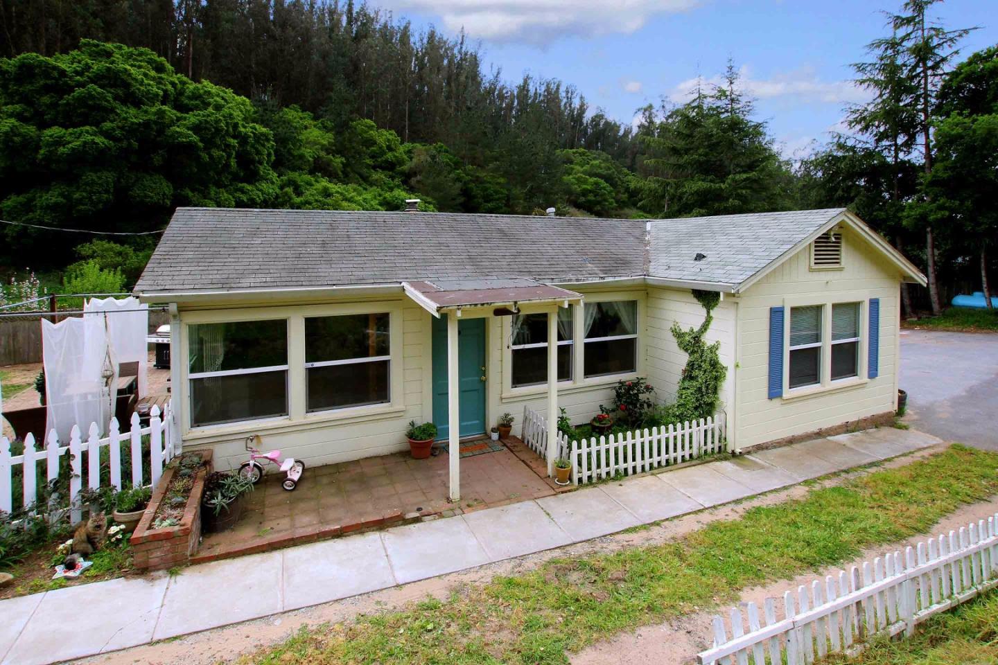 a view of house with outdoor space and garden
