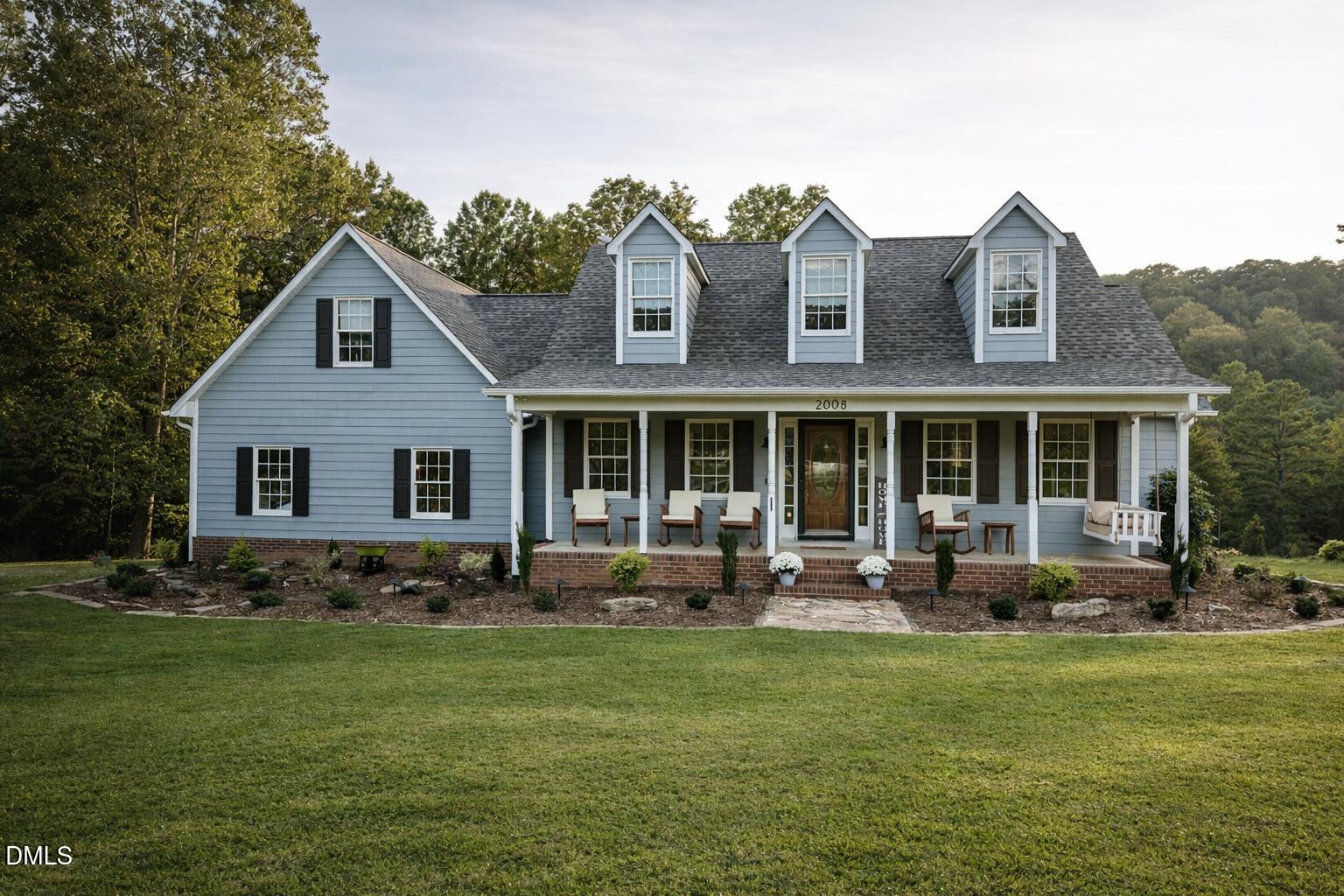 a front view of house with yard outdoor seating and barbeque oven