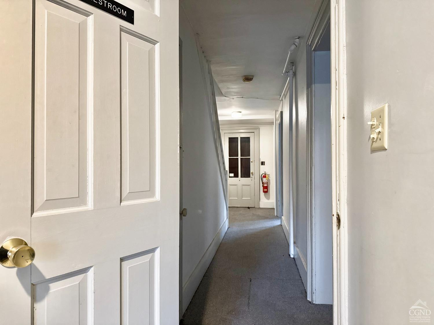 283 Main Street Catskill, NY 12414 - Photo 13 of 25 a view of a hallway with a white walls and stairs