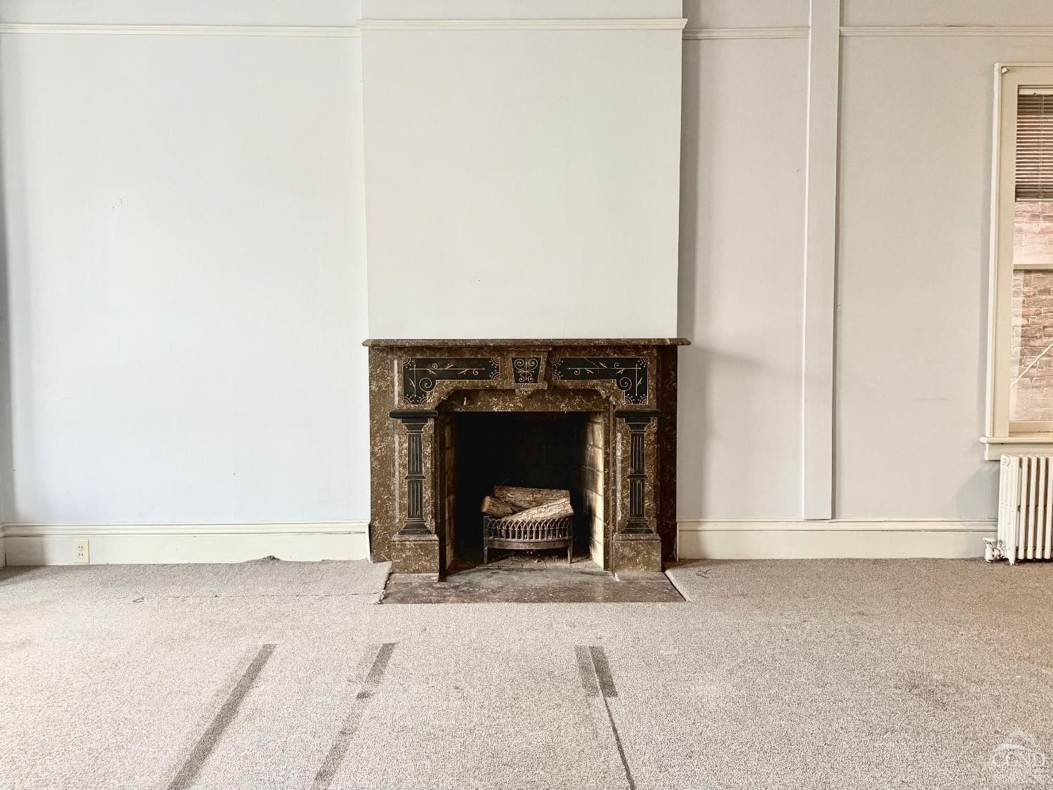 283 Main Street Catskill, NY 12414 - Photo 5 of 25 a view of a livingroom with a fireplace and a window