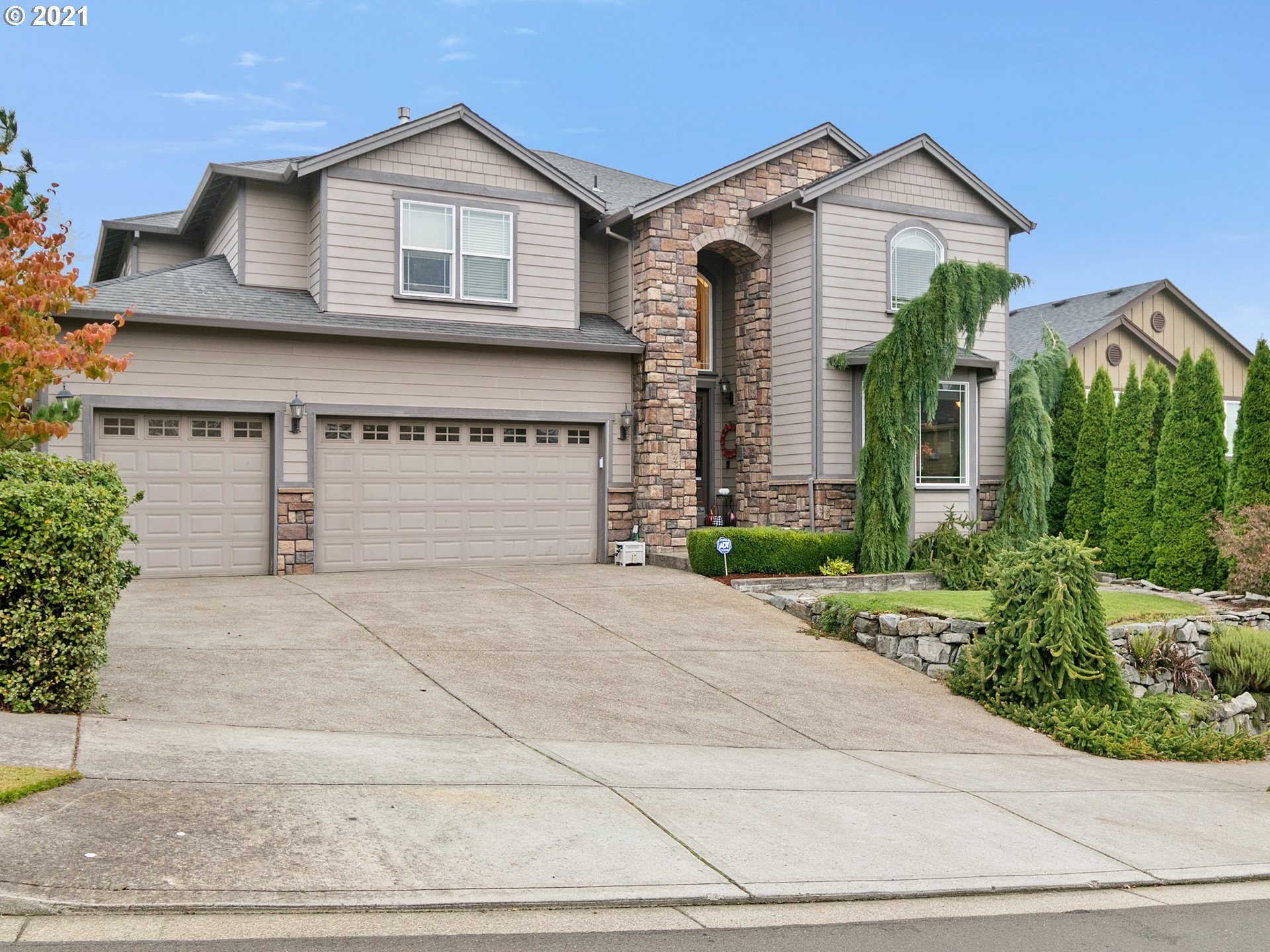 14741 Southeast Badger Creek Road Happy Valley, OR 97086 - Photo 2 of 32 a front view of a house with garden