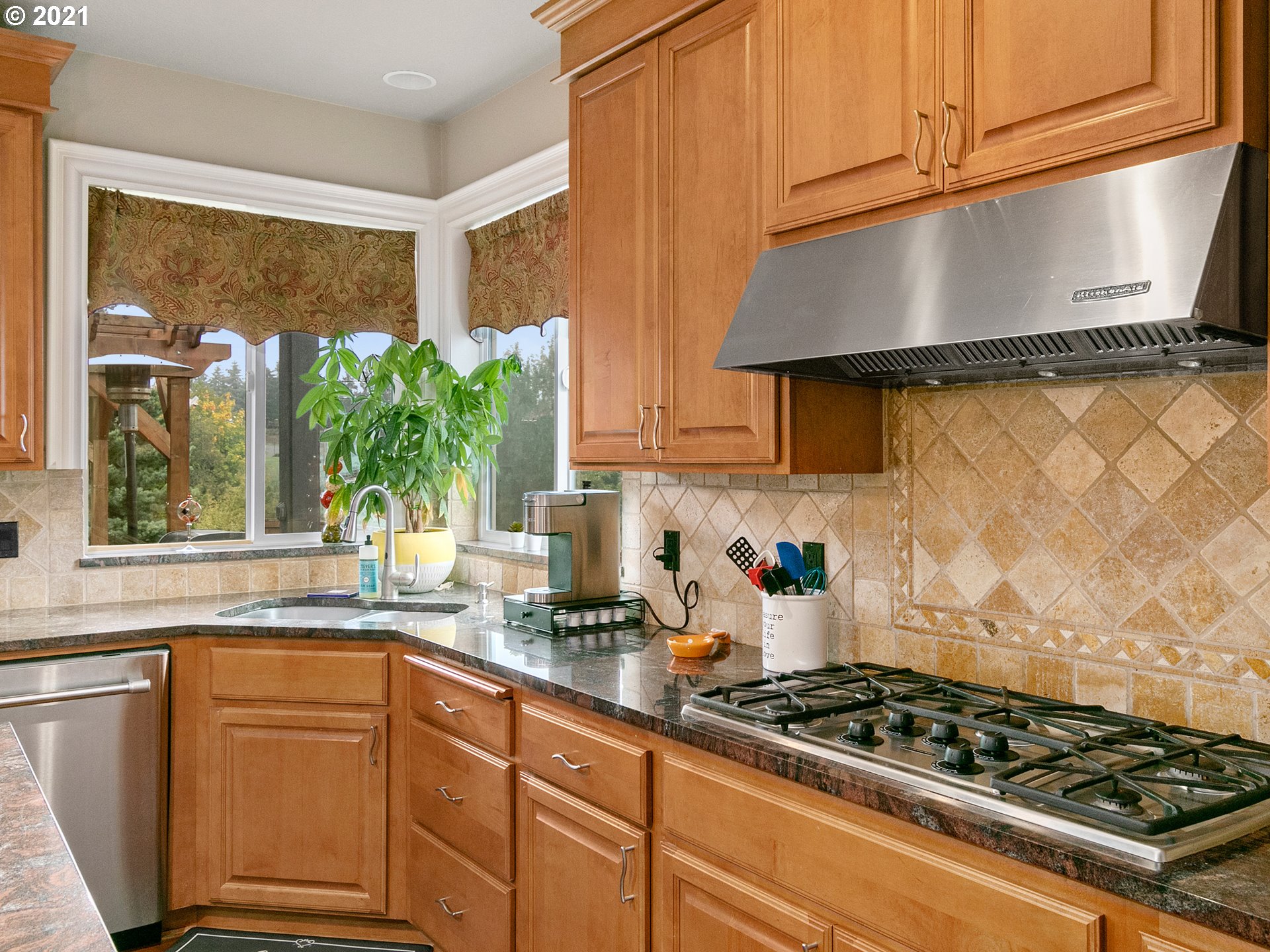14741 Southeast Badger Creek Road Happy Valley, OR 97086 - Photo 12 of 32 a kitchen with granite countertop a stove and a sink