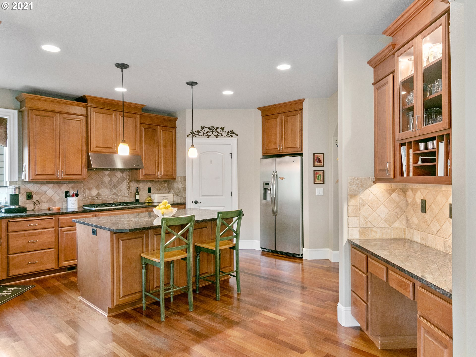 14741 Southeast Badger Creek Road Happy Valley, OR 97086 - Photo 14 of 32 a kitchen with a table chairs refrigerator and cabinets