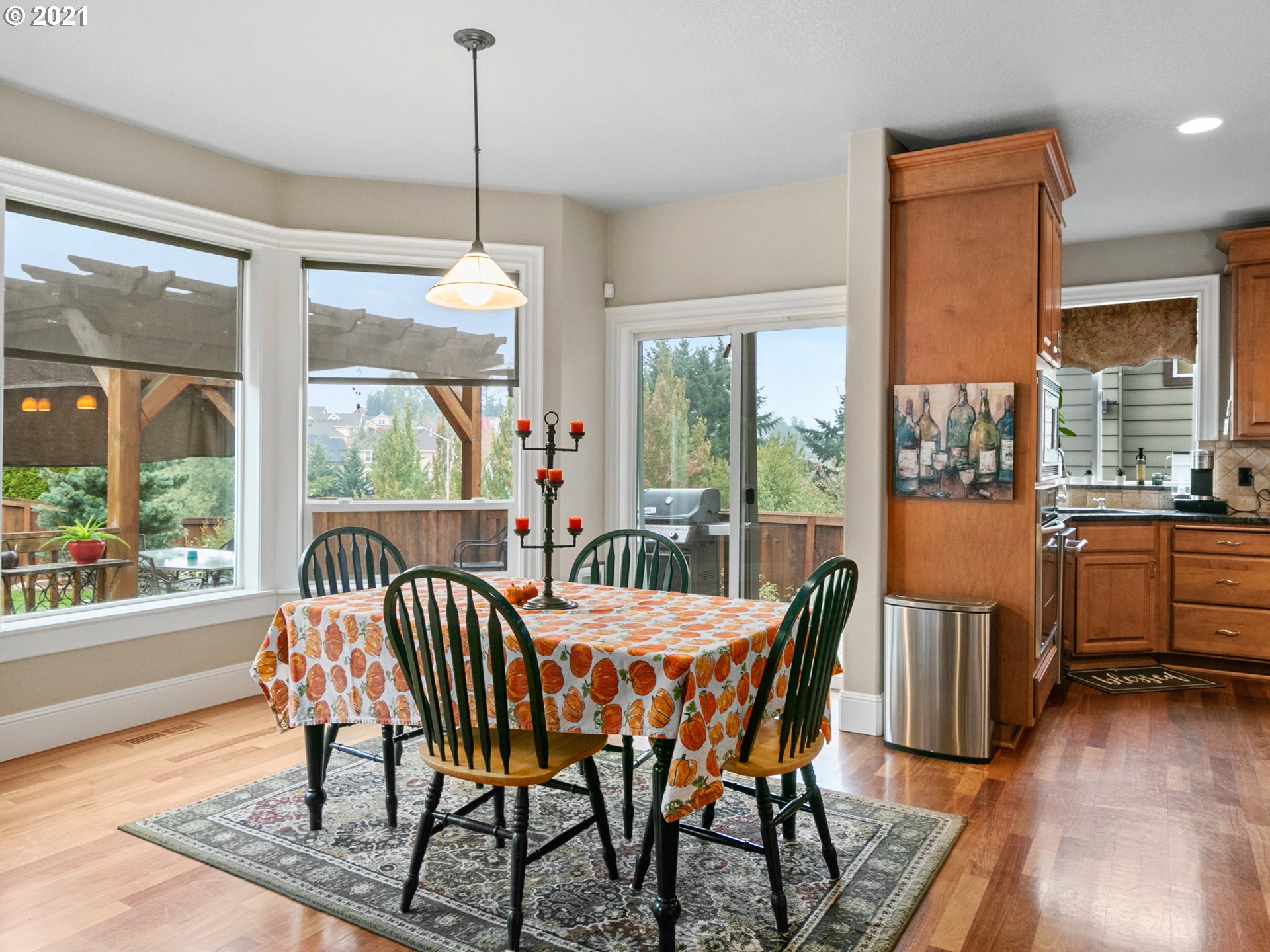 14741 Southeast Badger Creek Road Happy Valley, OR 97086 - Photo 15 of 32 a dining room with furniture a chandelier and wooden floor
