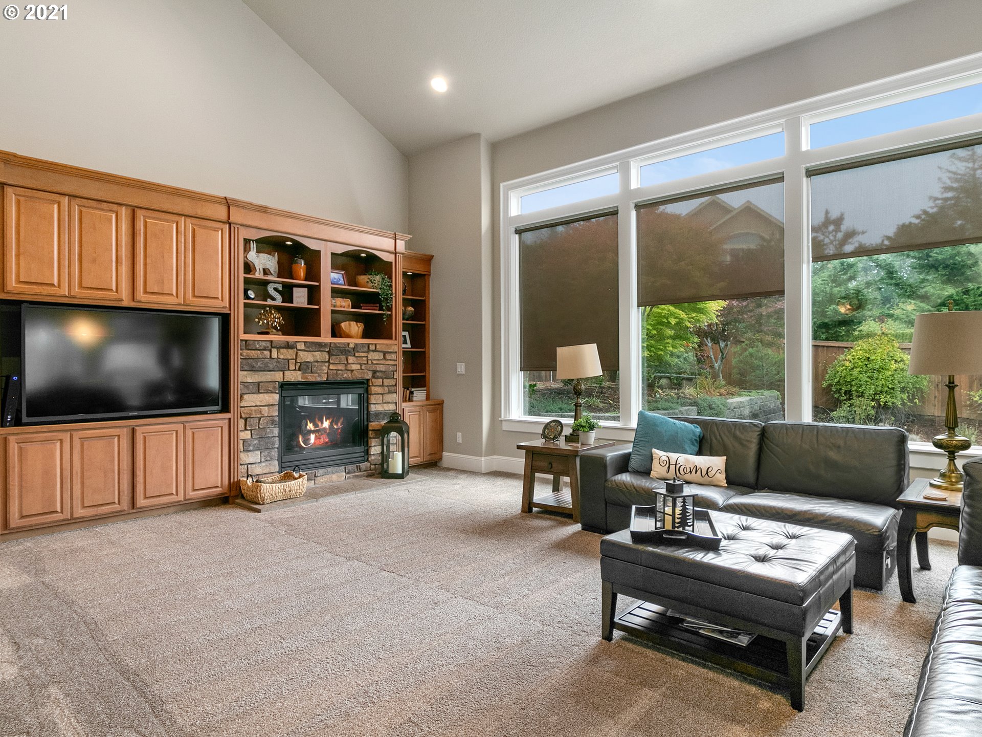 14741 Southeast Badger Creek Road Happy Valley, OR 97086 - Photo 17 of 32 a living room with furniture a flat screen tv and a fireplace