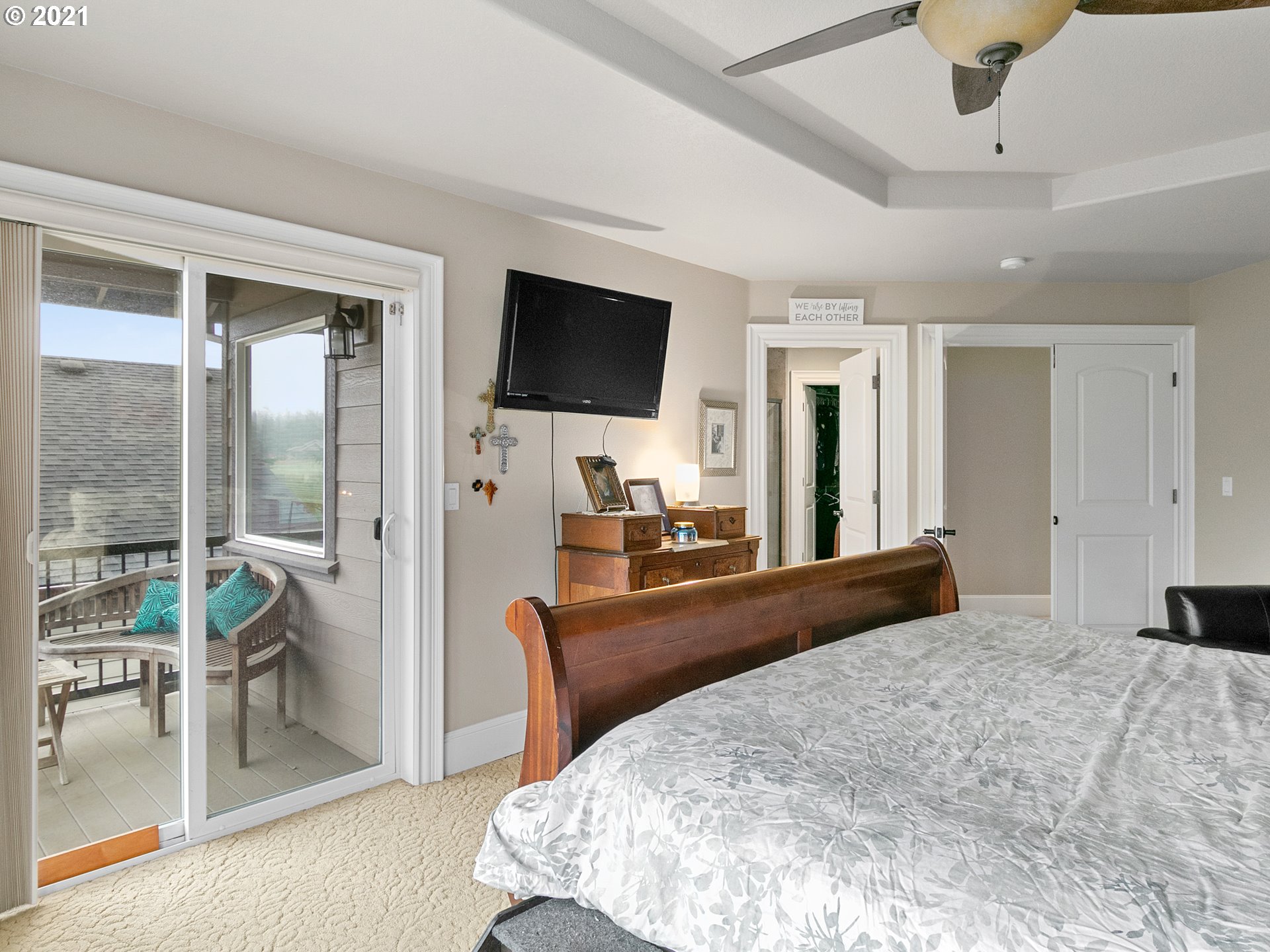 14741 Southeast Badger Creek Road Happy Valley, OR 97086 - Photo 21 of 32 a large bedroom with a large bed a flat screen tv and a large window