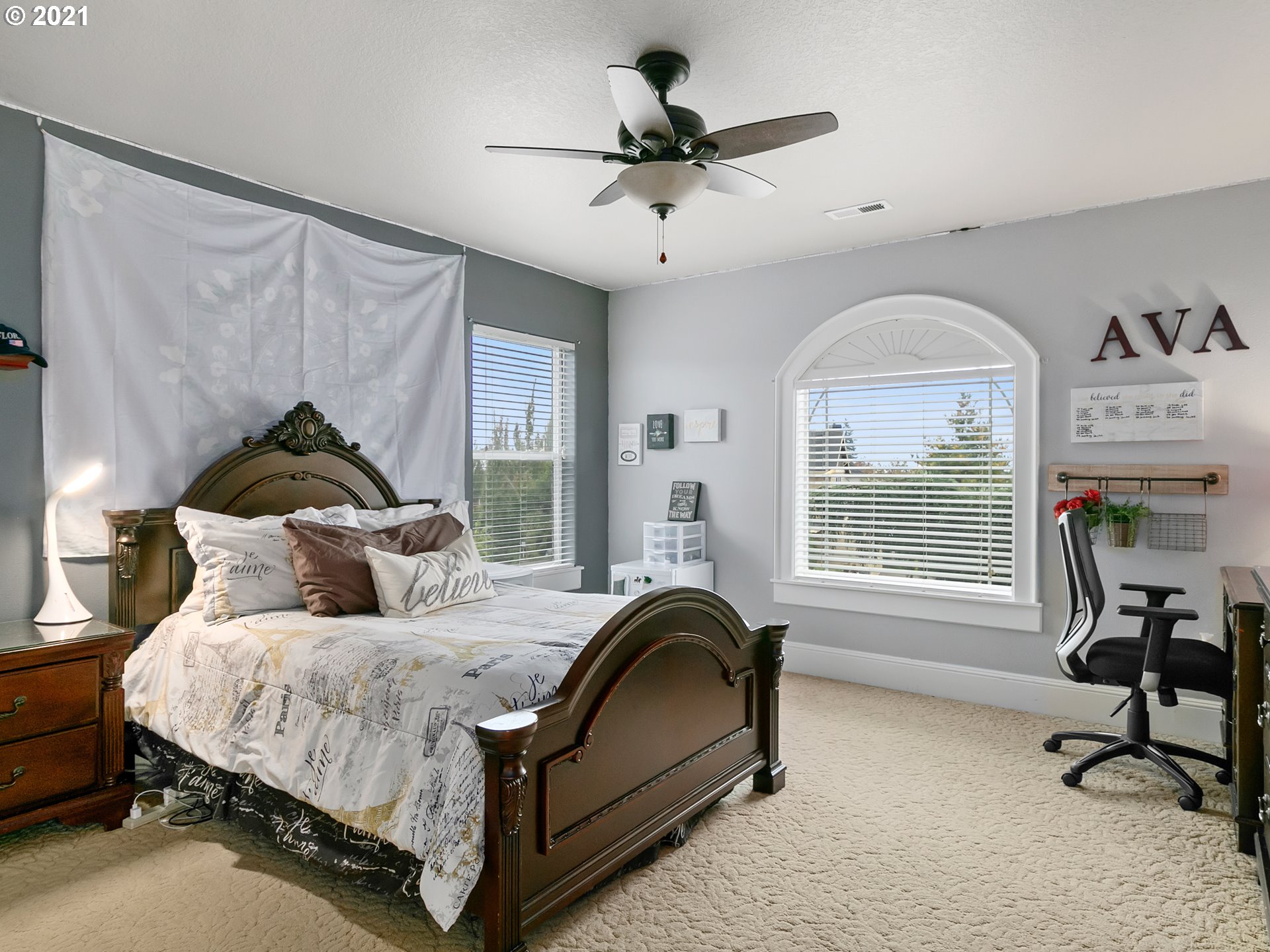 14741 Southeast Badger Creek Road Happy Valley, OR 97086 - Photo 24 of 32 a bedroom with a bed a window and a chandelier