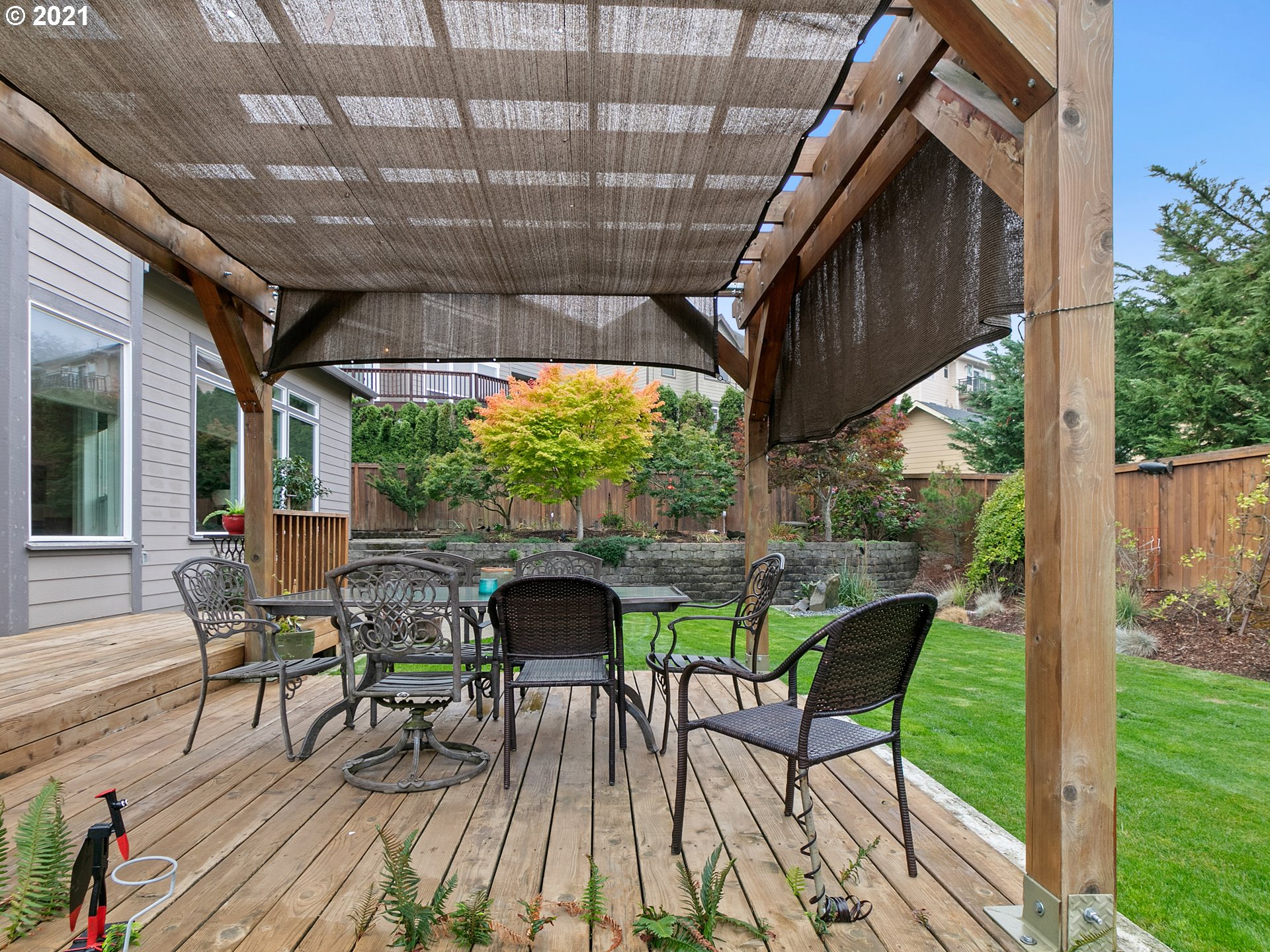 14741 Southeast Badger Creek Road Happy Valley, OR 97086 - Photo 28 of 32 a patio with glass windows and table