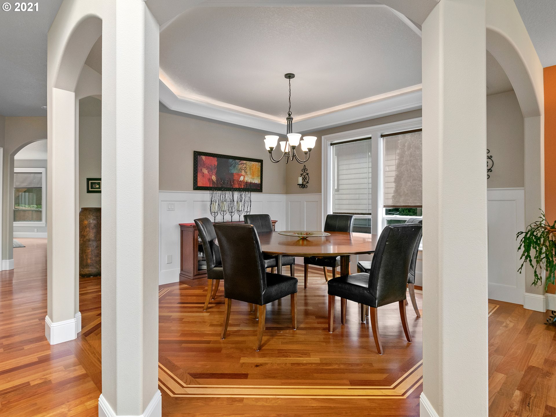 14741 Southeast Badger Creek Road Happy Valley, OR 97086 - Photo 7 of 32 a dining room with furniture a chandelier and wooden floor