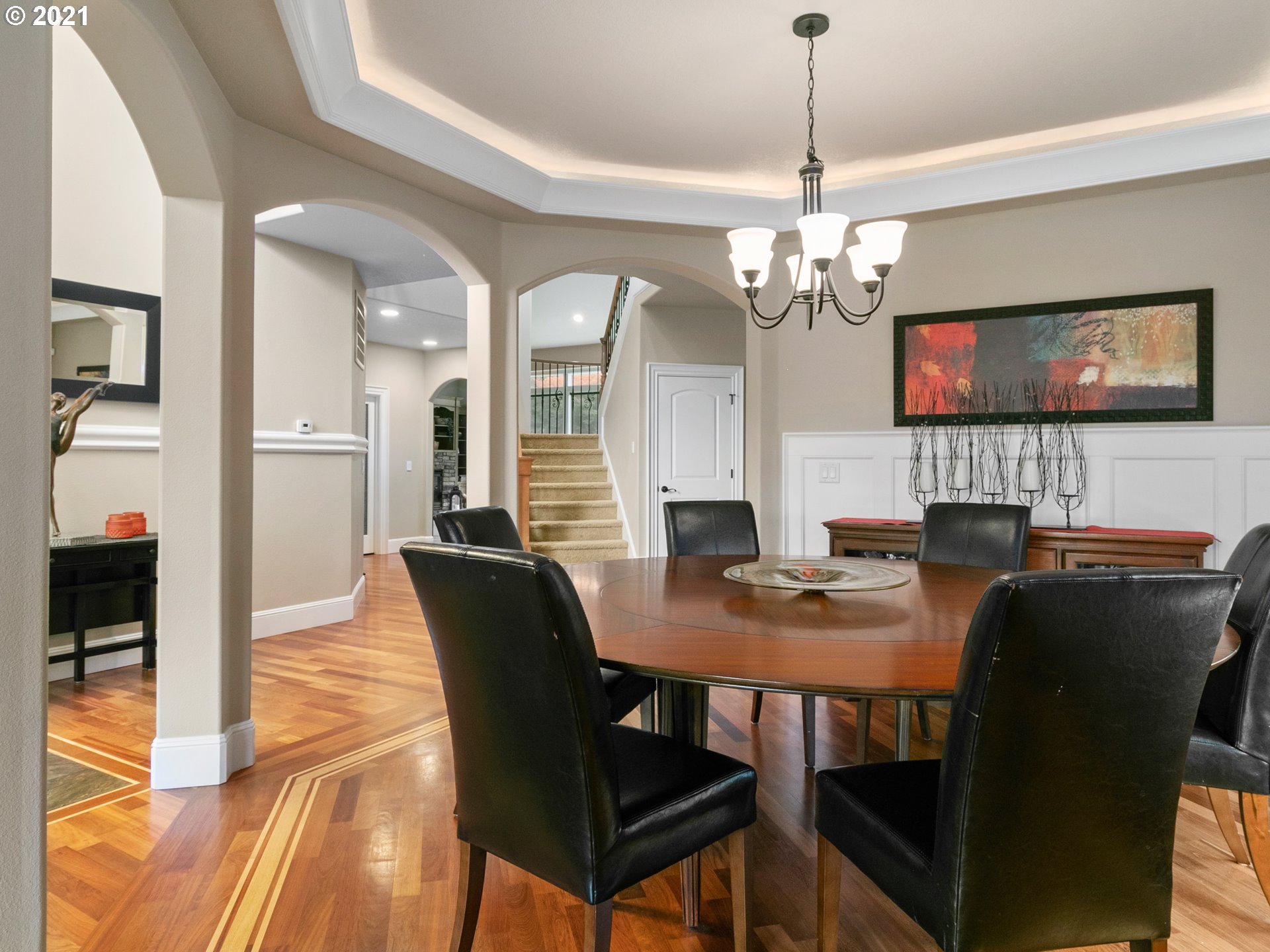 14741 Southeast Badger Creek Road Happy Valley, OR 97086 - Photo 8 of 32 a view of a dining room with furniture a chandelier and wooden floor