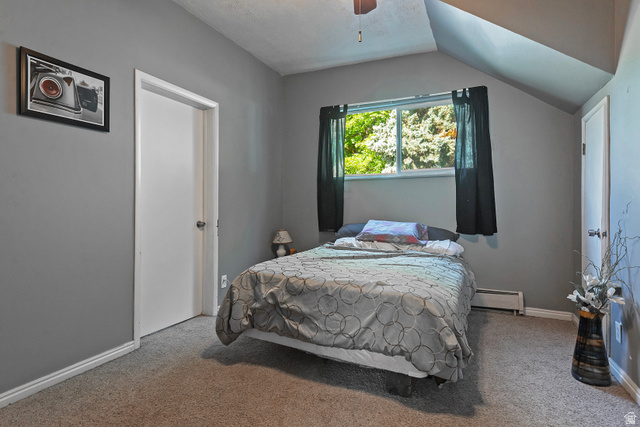 178 17th Street Ogden, UT 84404 - Photo 19 of 29 Carpeted room featuring a window with exterior tree scenery, sloped ceiling, and ceiling fan