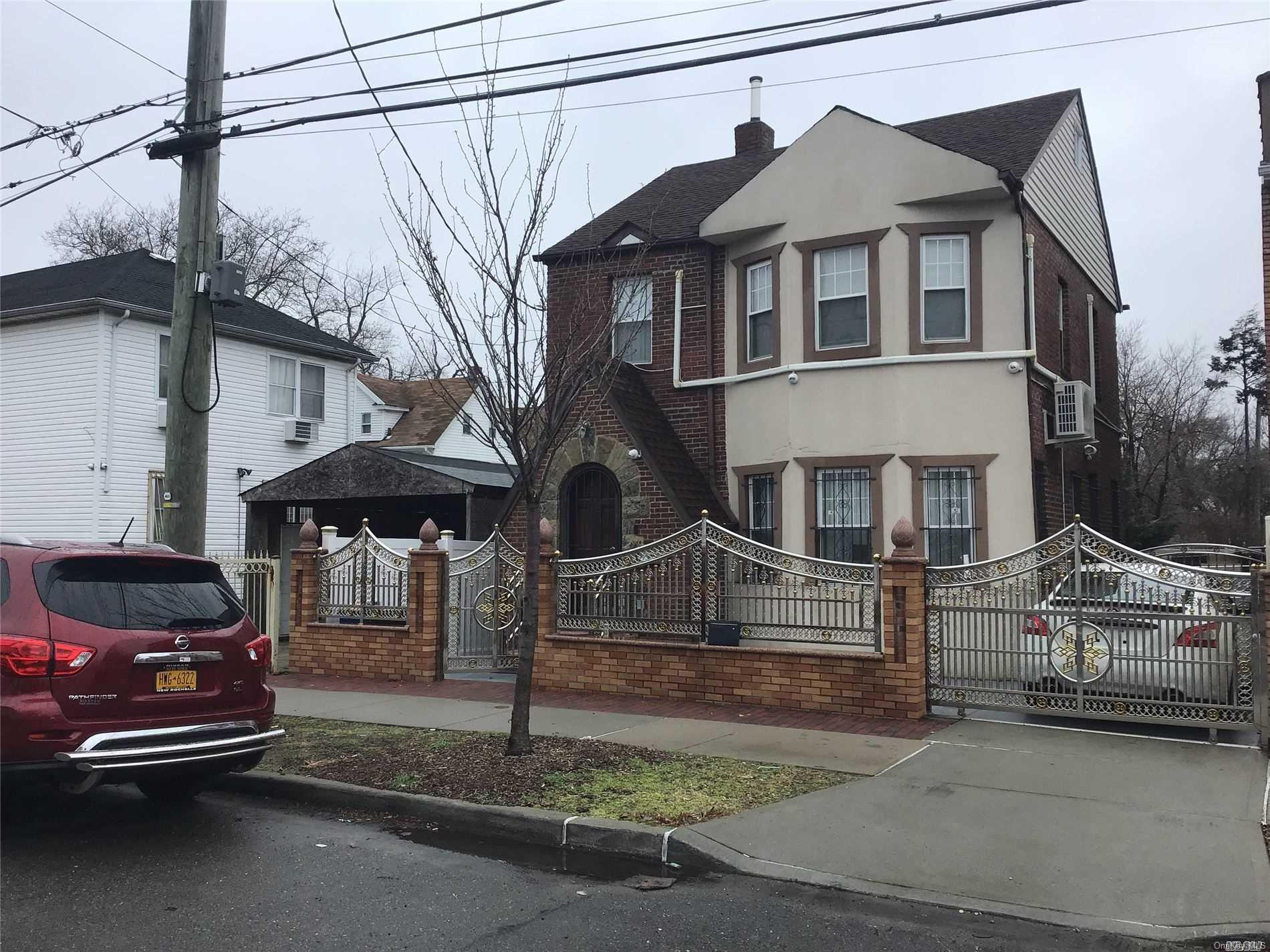 164-11 Brinkerhoff Avenue Queens, NY 11433 - Photo 1 of 1 a front view of a house with parking space