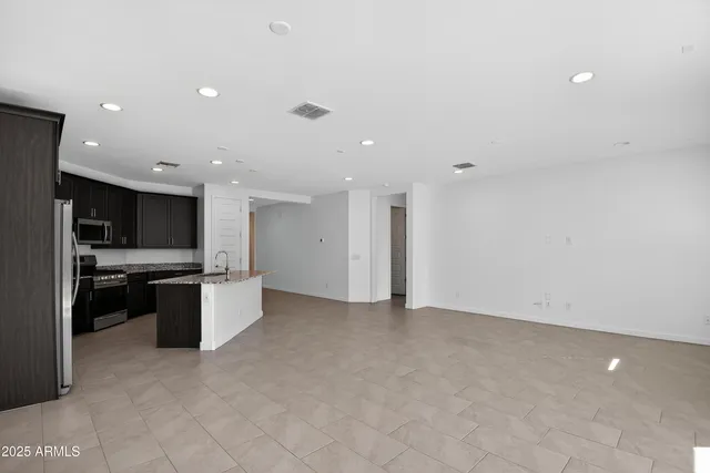 a view of kitchen with refrigerator sink and stove
