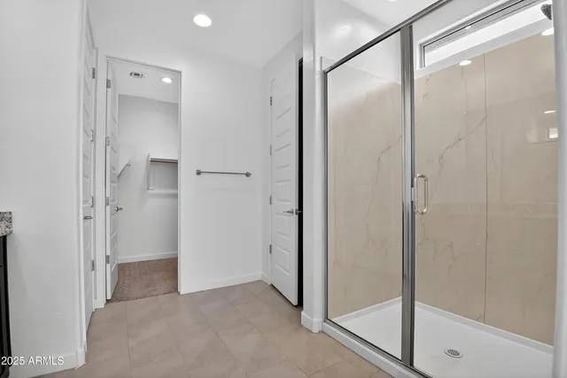 a bathroom with a glass shower door