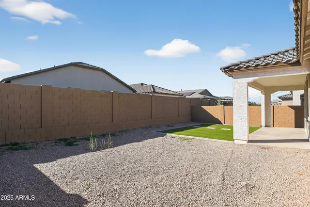 a view of backyard of house and car parked