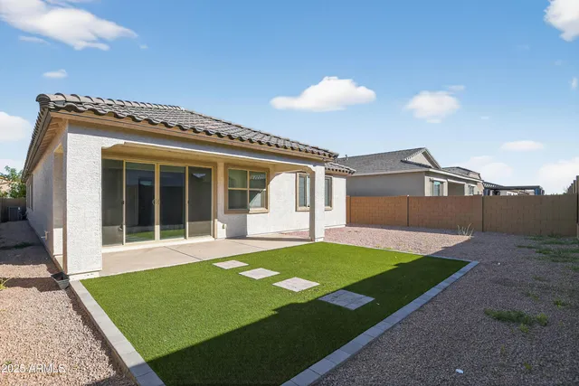 a view of a house with backyard and porch