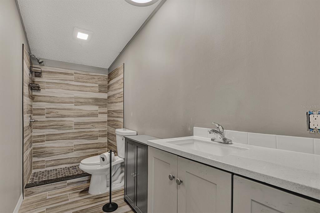 141 Woods Road San Mateo, FL 32187 - Photo 16 of 66 a bathroom with a sink toilet and shower