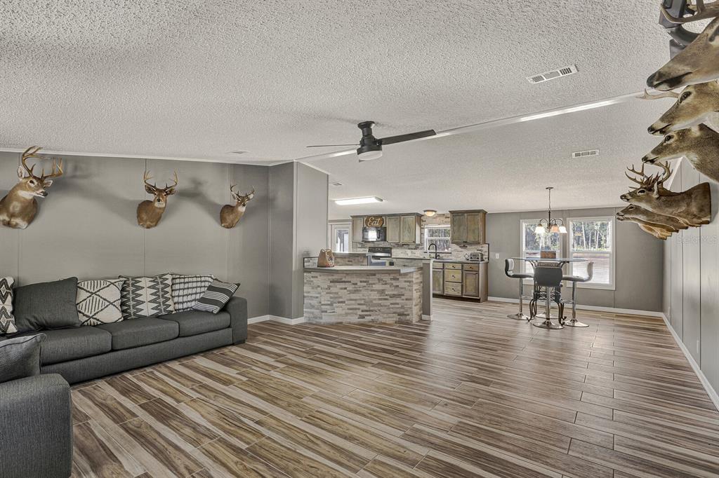 141 Woods Road San Mateo, FL 32187 - Photo 20 of 66 a living room with furniture and wooden floor