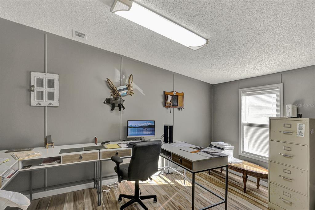 141 Woods Road San Mateo, FL 32187 - Photo 28 of 66 a view of a workspace with furniture