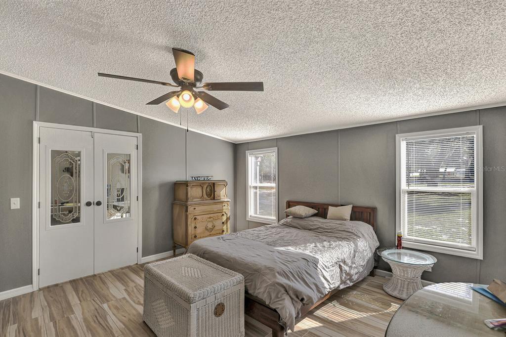 141 Woods Road San Mateo, FL 32187 - Photo 30 of 66 a bedroom with a bed and a chandelier