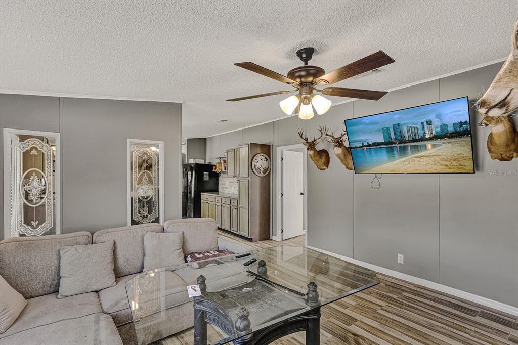 141 Woods Road San Mateo, FL 32187 - Photo 37 of 66 a living room with furniture a ceiling fan and a rug