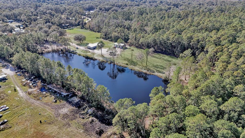 141 Woods Road San Mateo, FL 32187 - Photo 40 of 66 an aerial view of a house with a yard