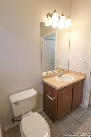 a bathroom with a sink a toilet and mirror