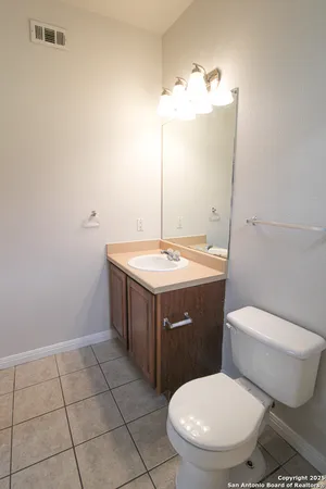 a bathroom with a sink a toilet and mirror