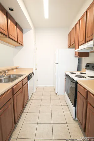 a kitchen with a sink a stove and cabinets