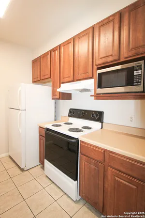a kitchen with a sink and a refrigerator