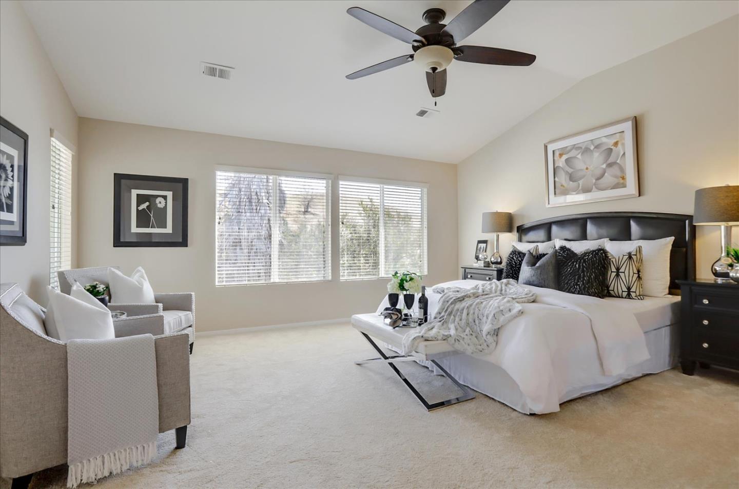 546 Esplanade Lane San Jose, CA 95138 - Photo 15 of 24 a bed sitting in a bedroom next to a window with a chandelier