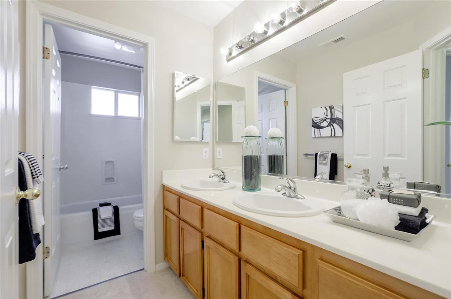 546 Esplanade Lane San Jose, CA 95138 - Photo 17 of 24 a bathroom with a double vanity sink a mirror and shower