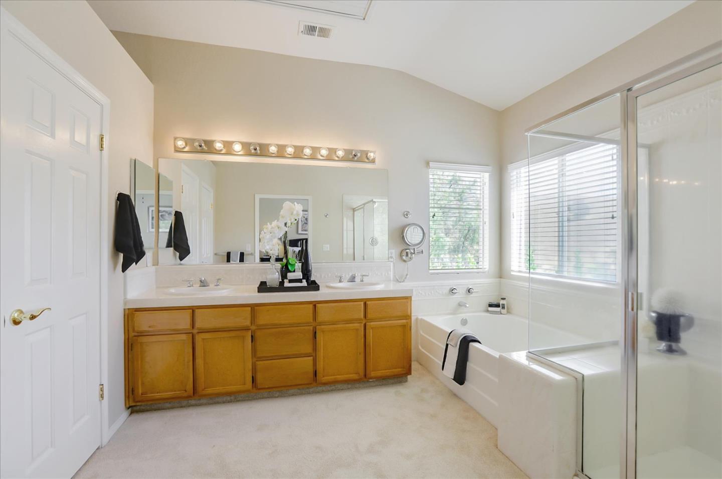546 Esplanade Lane San Jose, CA 95138 - Photo 18 of 24 a spacious bathroom with a tub sink and mirror