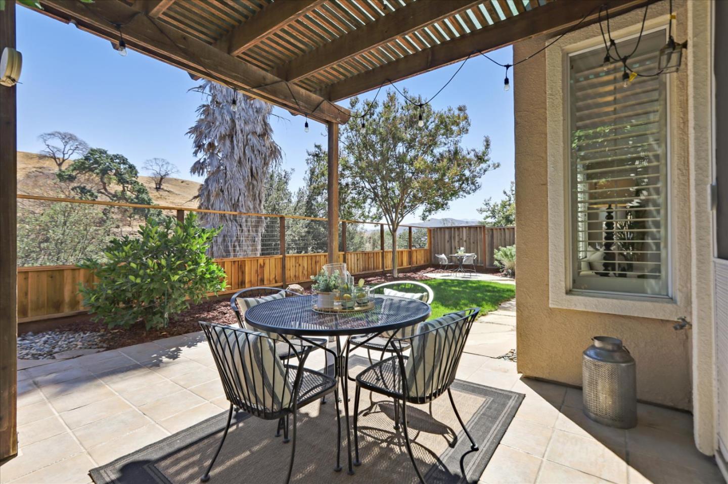 546 Esplanade Lane San Jose, CA 95138 - Photo 22 of 24 a view of a patio with a table and chairs and potted plants