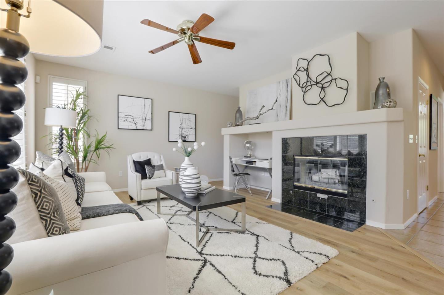546 Esplanade Lane San Jose, CA 95138 - Photo 3 of 24 a living room with furniture a flat screen tv and a fireplace