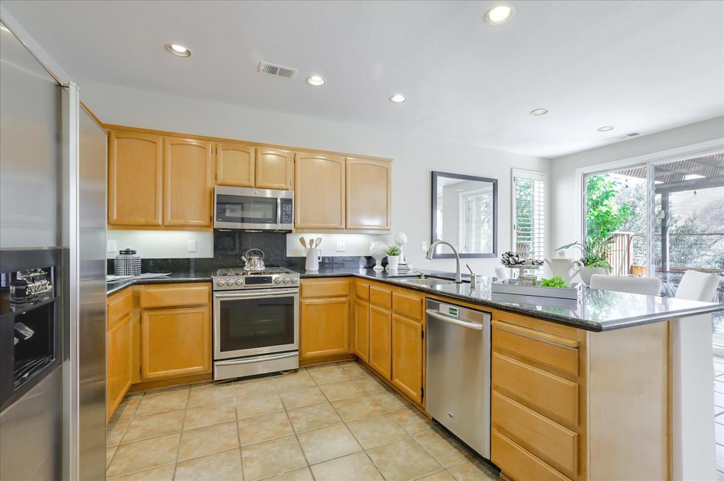 546 Esplanade Lane San Jose, CA 95138 - Photo 5 of 24 a kitchen with stainless steel appliances granite countertop a sink and cabinets