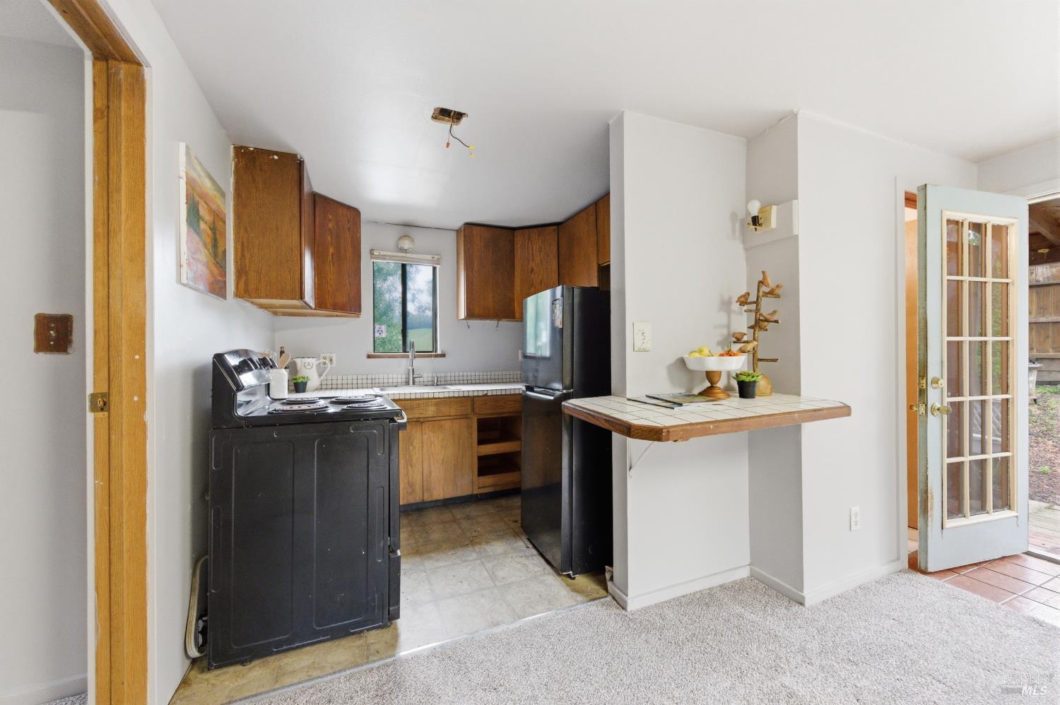 9489 Rio Vista Road Forestville, CA 95436 - Photo 15 of 32 a kitchen with a sink stove and cabinets