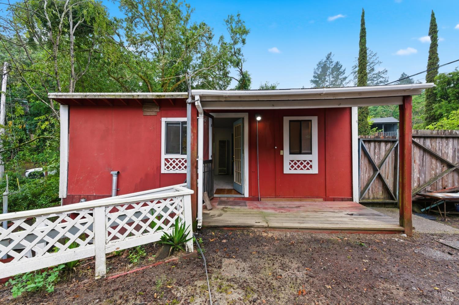 9489 Rio Vista Road Forestville, CA 95436 - Photo 10 of 32 a view of a house with a small yard and wooden fence