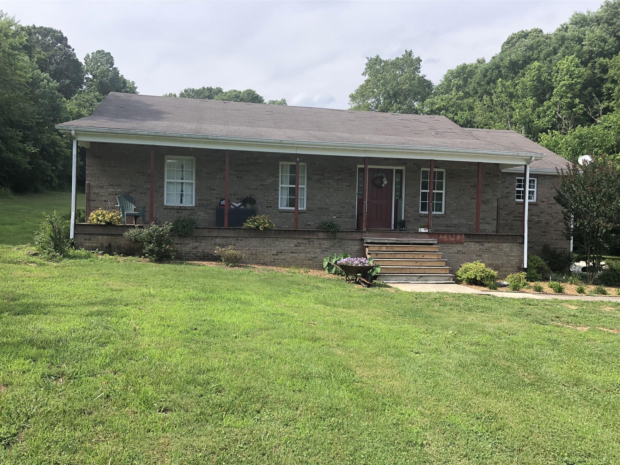 1073 Ervin Pace Road Chapmansboro, TN 37035 - Photo 2 of 19 Rocking Chair front porch reminiscent of Cracker Barrel except on five extremely gorgeous and secluded acres.