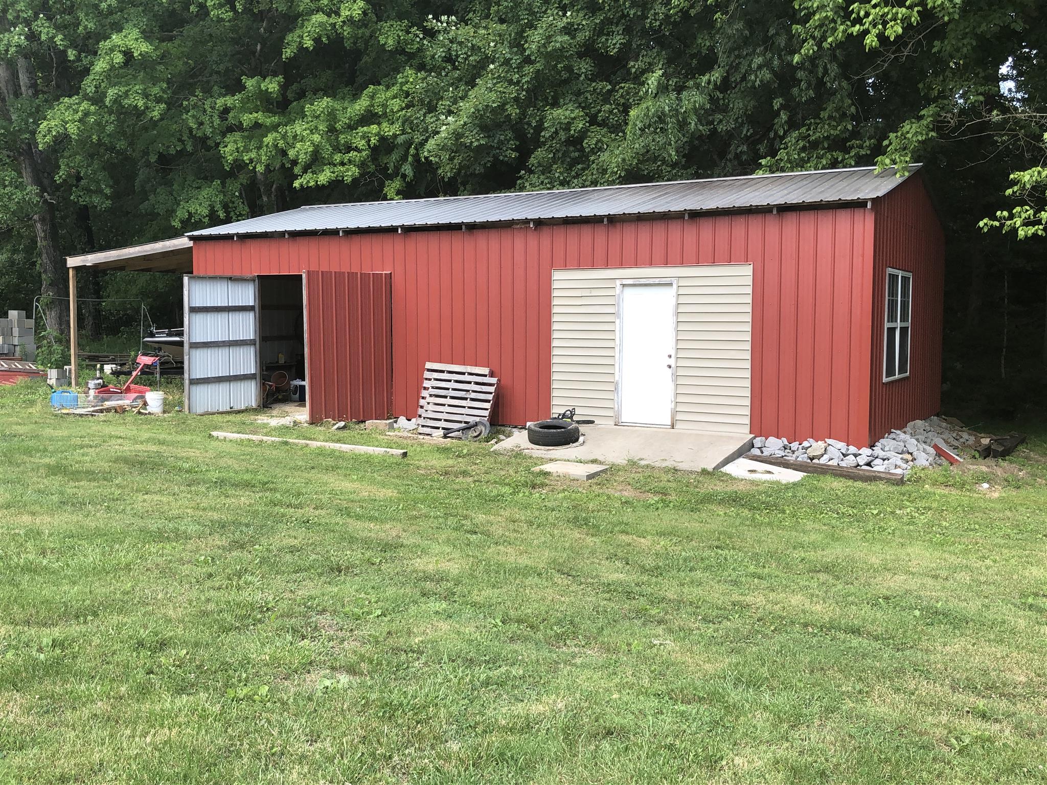 1073 Ervin Pace Road Chapmansboro, TN 37035 - Photo 5 of 19 this 20 x 40 out building is split between an implement / storage area and a workout room that is insulated and has electricity.