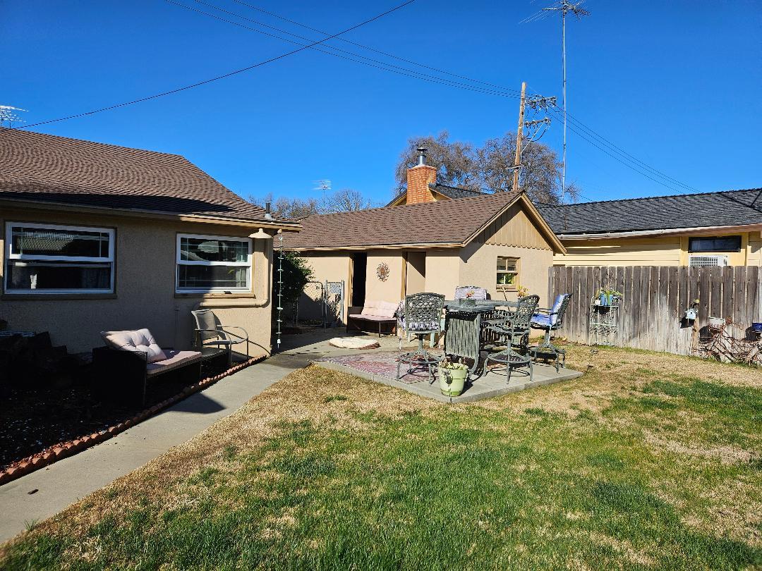 653 Center Street Princeton, CA 95970 - Photo 3 of 13 a view of a patio with table and chairs a barbeque