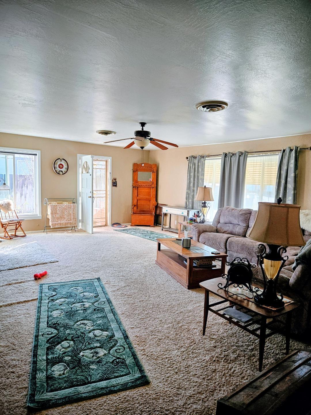 653 Center Street Princeton, CA 95970 - Photo 4 of 13 a living room with furniture and a rug