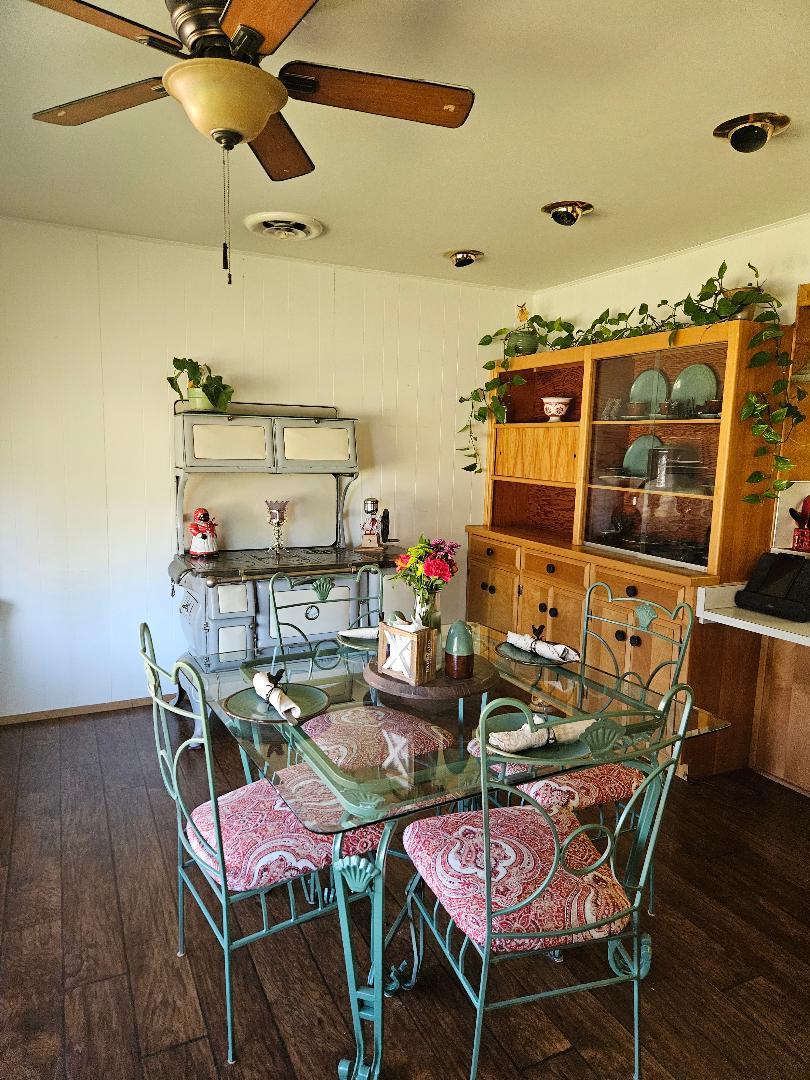 653 Center Street Princeton, CA 95970 - Photo 7 of 13 a view of a dining room with furniture and wooden floor