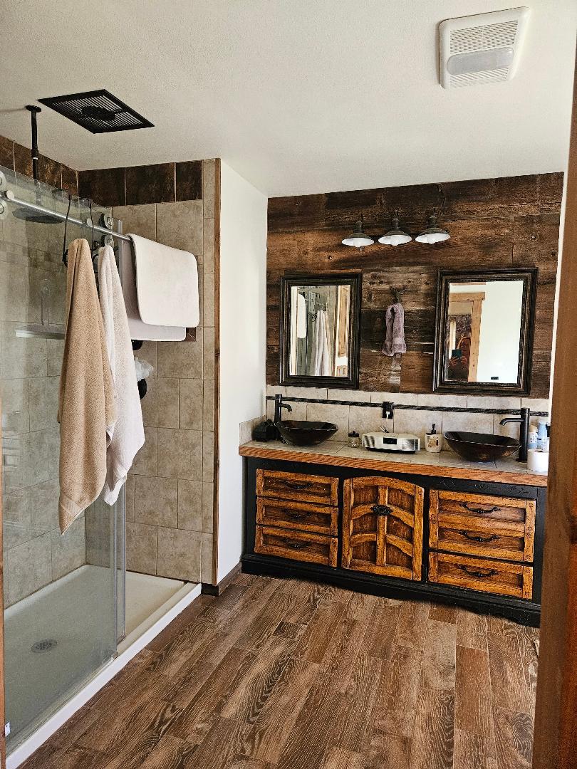 653 Center Street Princeton, CA 95970 - Photo 9 of 13 a en suite bathroom with a double vanity sink and a mirror