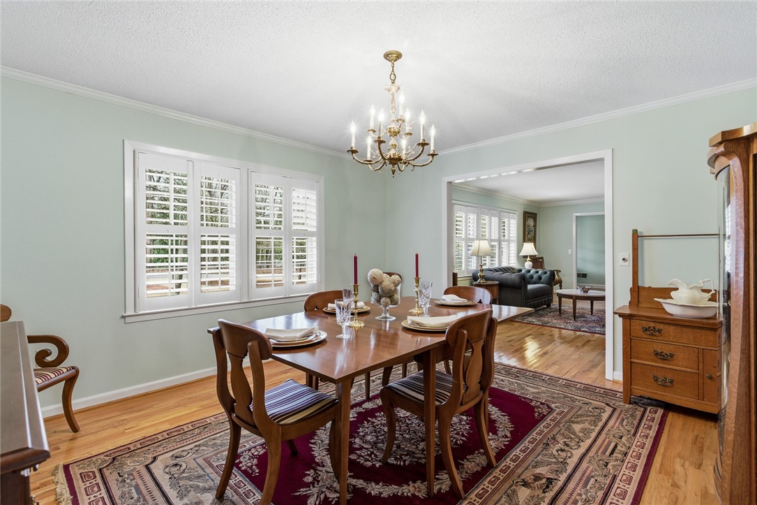 106 Cherokee Circle Anderson, SC 29621 - Photo 11 of 47 This elegant dining room features rich wood flooring and classic window shutters, perfect for entertaining.